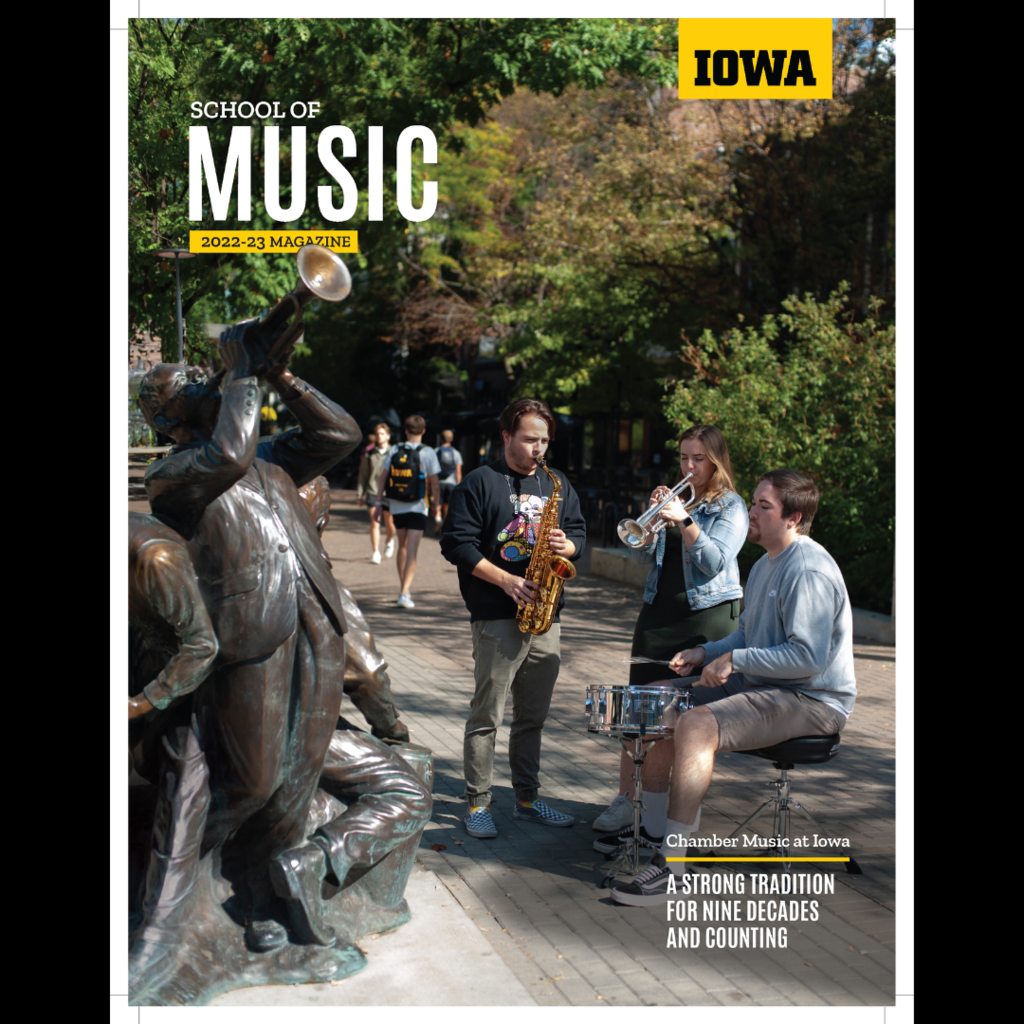 cover of 2023 Iowa Music Magazine, featuring a small jazz ensemble of student musicians playing their instruments on the ped mall in Iowa City, next to a bronze statue of jazz musicians