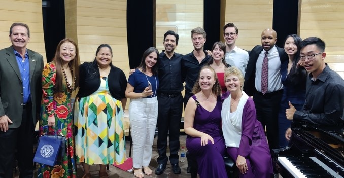 Twelve UI and Brazilian Pianist Pose with May Baptista, the Consul General at the United States Consulate General in Recife after Performing "The People United Will Never Be Defeated"