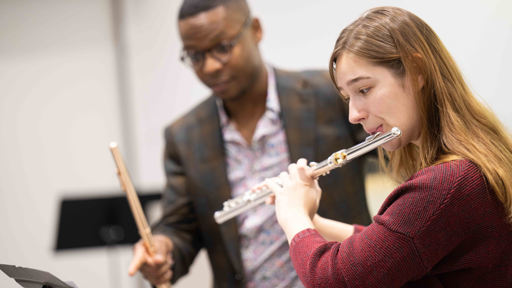 a flute student plays her instrument during a master class in voxman music building