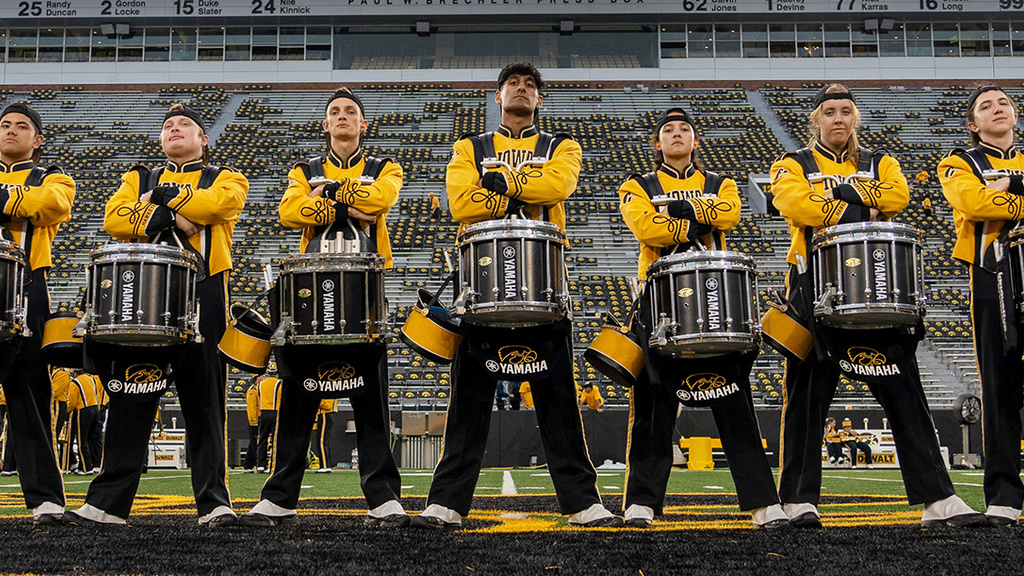Band Extravaganza promo image of band members in black and gold uniforms