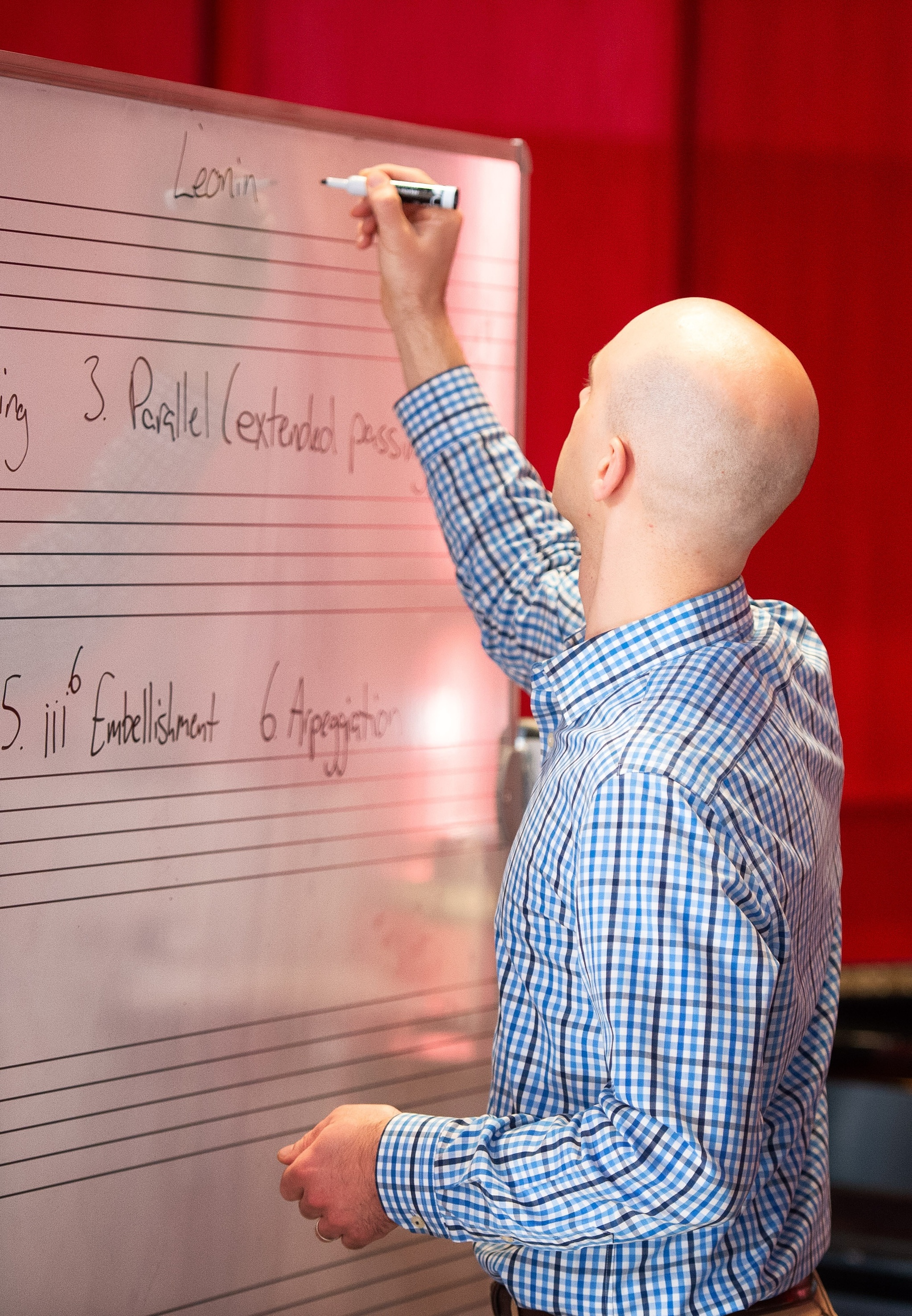 Instructor writing on a whiteboard in the classroom