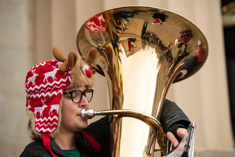 Close up of a tuba player during Holiday Tubas performance on Old Capitol steps