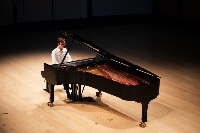 pianist performing on concert hall stage