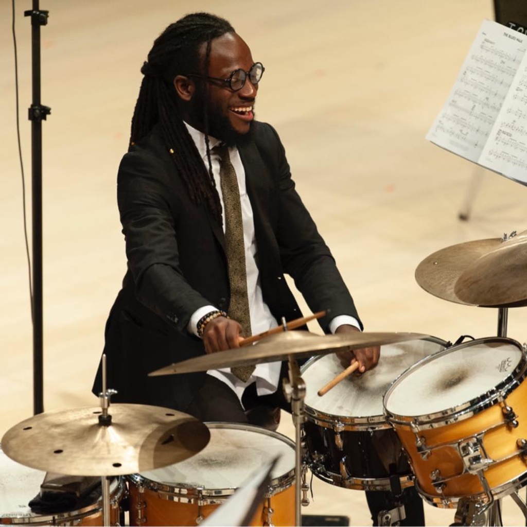 Jerome Gillespie playing drums onstage in Voxman Music Building Concert Hall