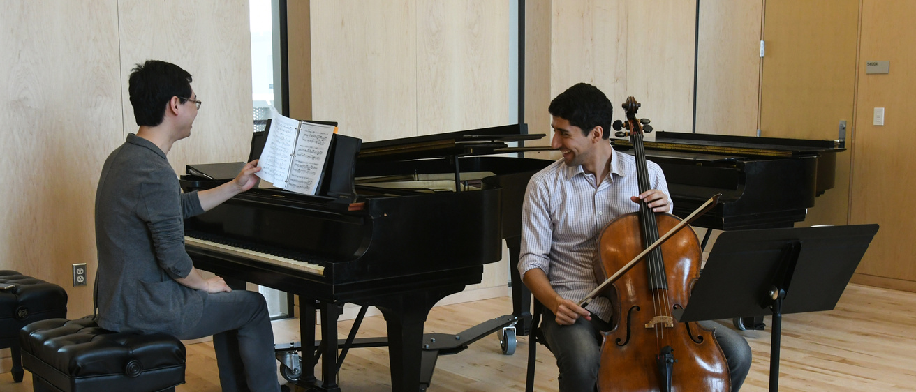 a collaborative pianist (left) preparwes to play music alongside a cellist (right)