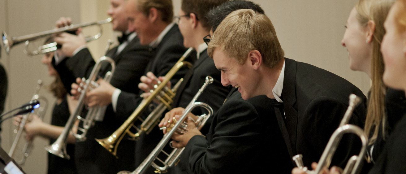 a group of trumprt players onstage at Concert Hall