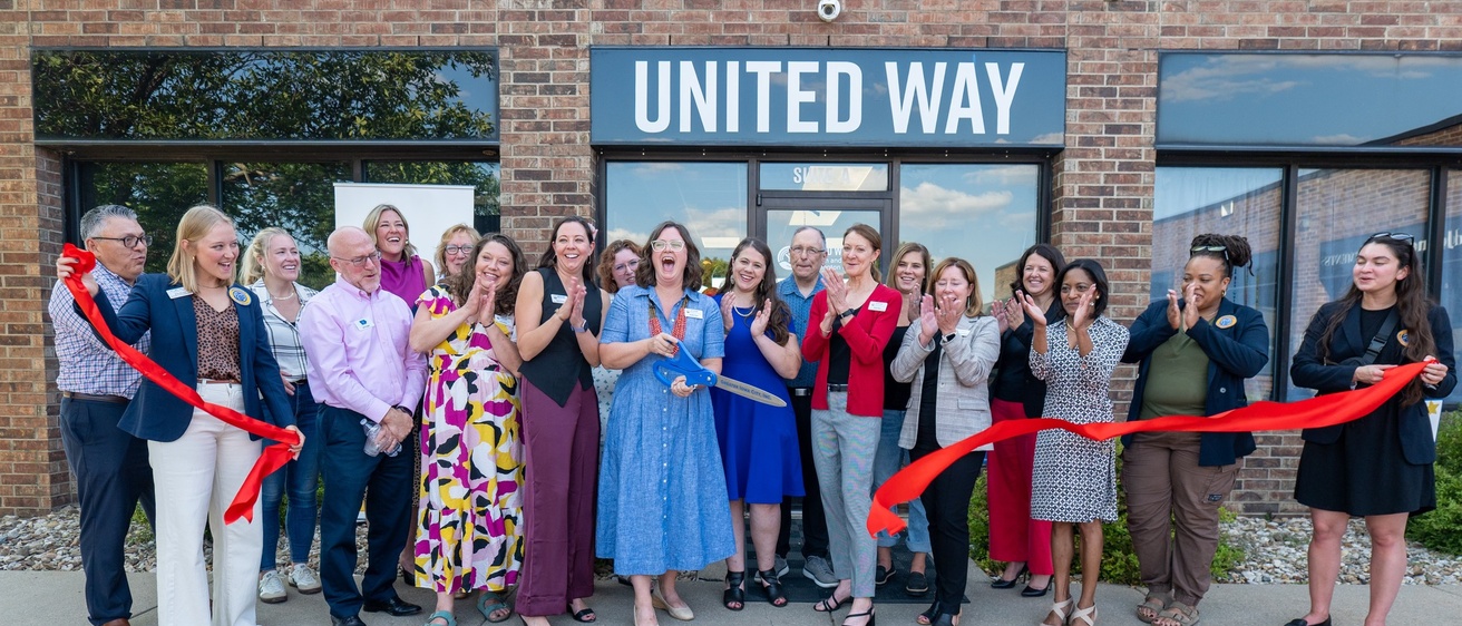 Staff and board members of United Way of Johnson and Washington Counties cut the ribbon to dedicate their new office space