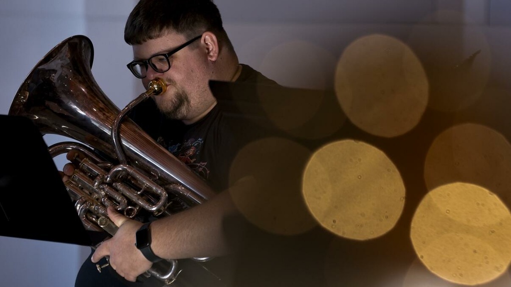 Drew Bonner, DMA candidate in Euphonium Performance practicing music for Holiday Tubas