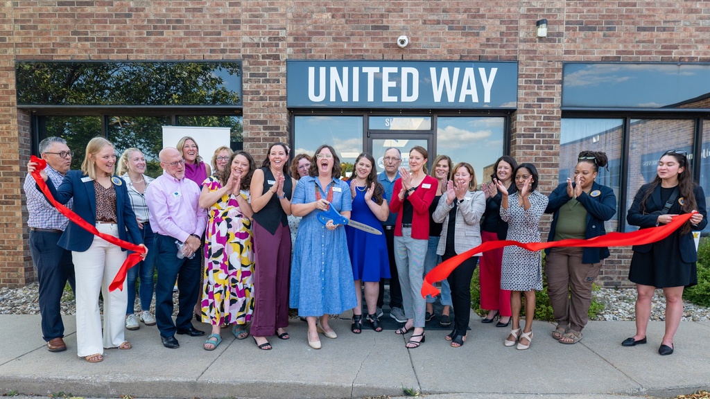 Staff and board members of United Way of Johnson and Washington Counties cut the ribbon to dedicate their new office space