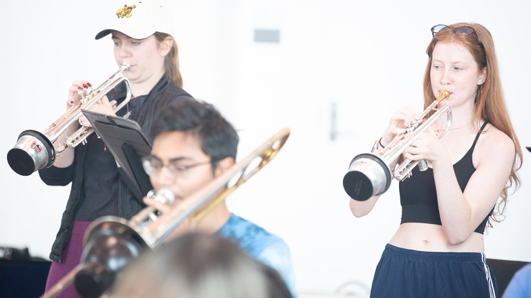 student musicians playing trumpets in a Voxman classroom
